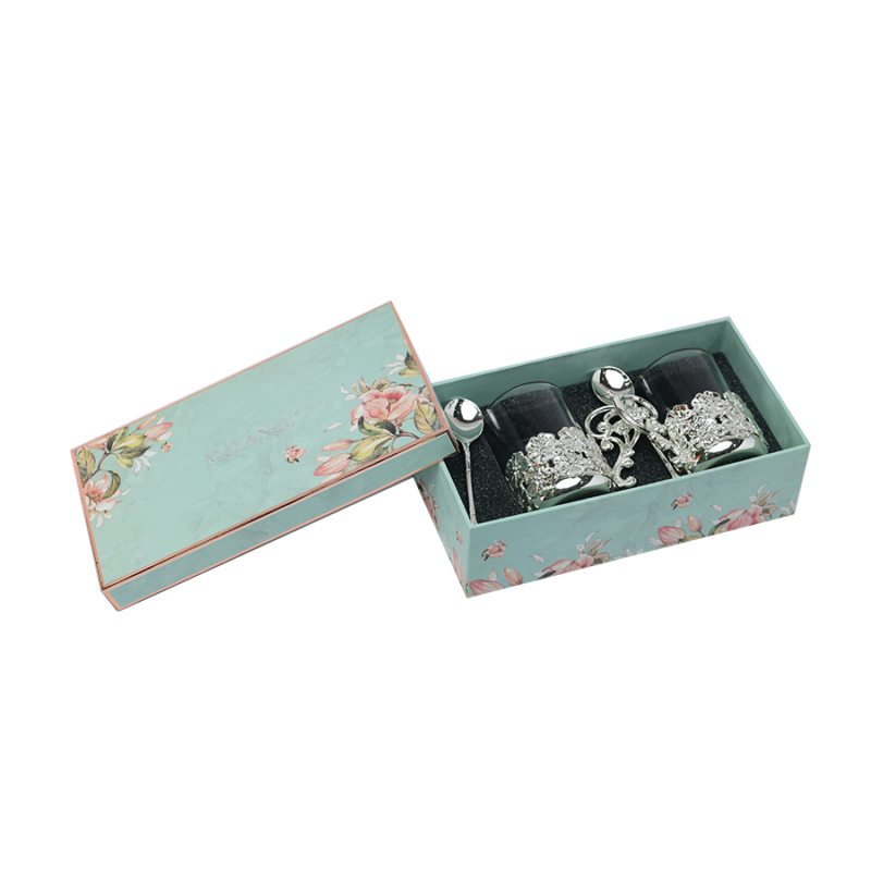 a silver plated set of two mugs kept in a box