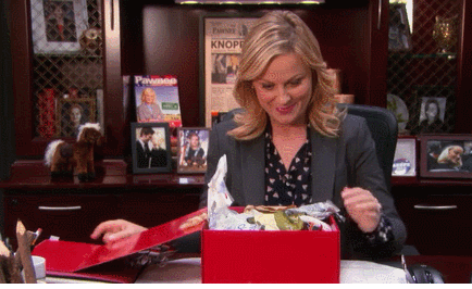 a lady opening a gift box and discovering trash