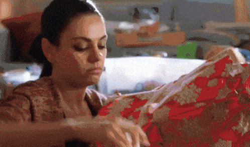 a girl packing a gift with all her creativity and then tossing it away